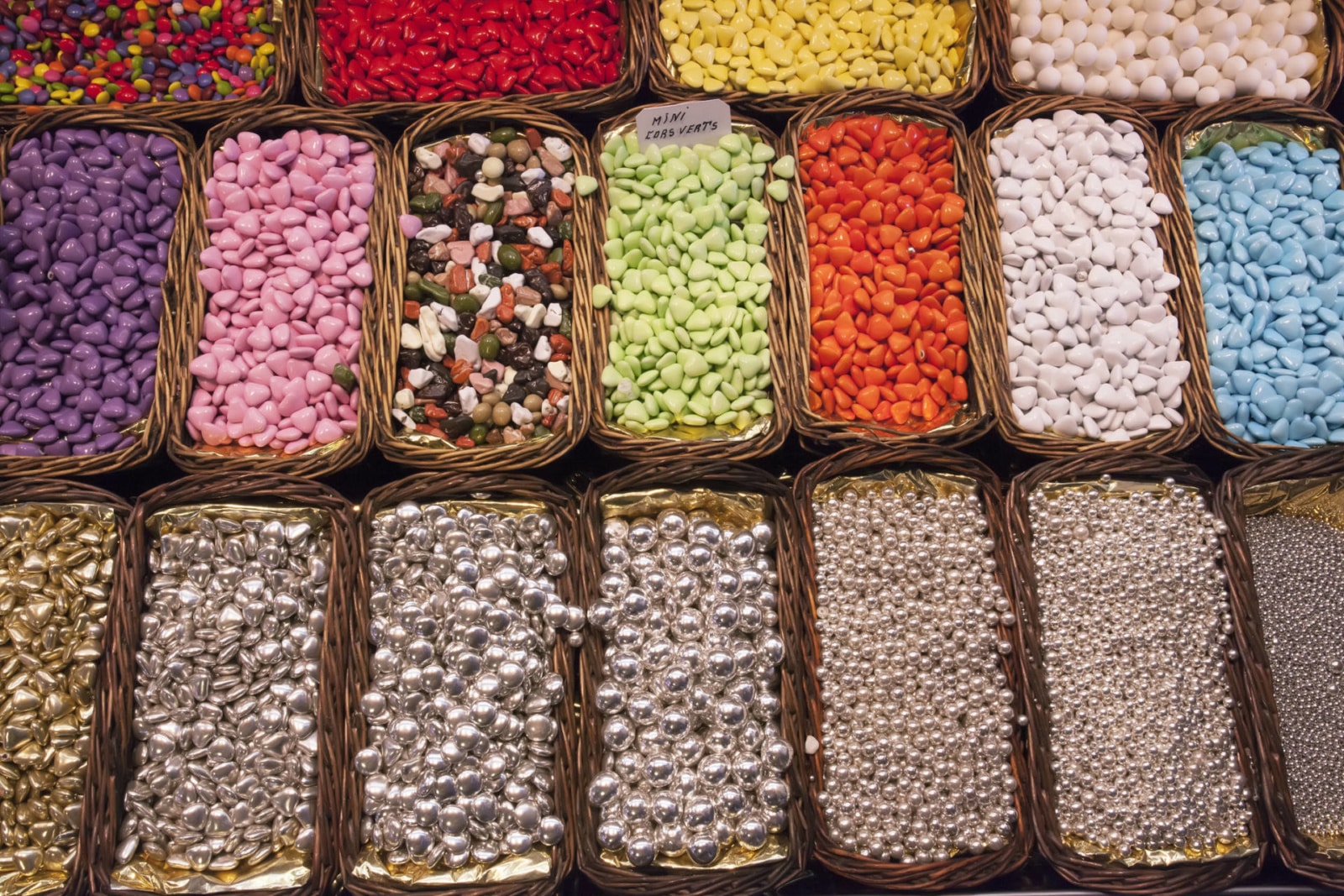 sweets, jelly beans of different colors, in baskets on the shelves, Spain