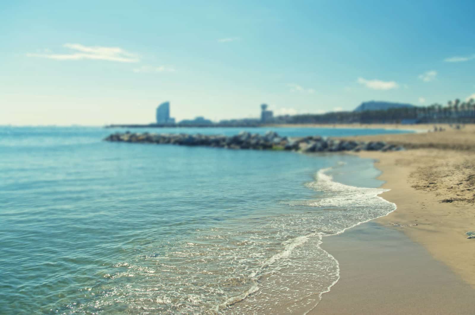 cross-processed background image of Barcelona beach on sunny spring day with shallow depth of field, Spain