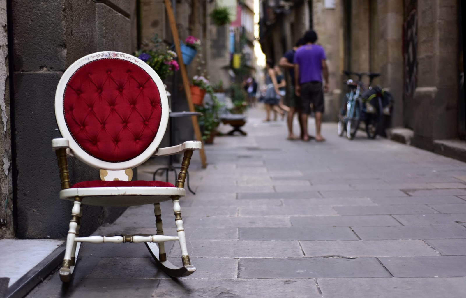 a view of a pedestrian street in the Born district, in Barcelona, Spain, with an old rocker in the foreground