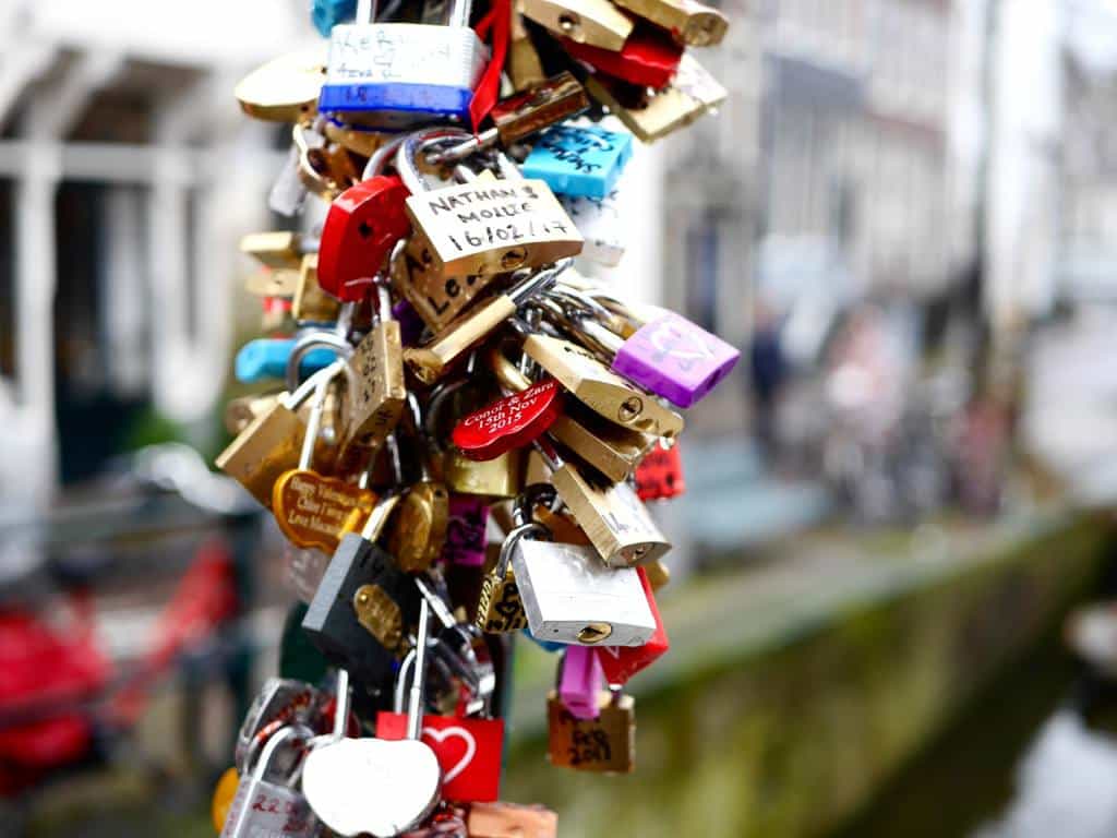 Padlocks on the love lock bridge in Amsterdam. One of the most Instagrammable places in Amsterdam.